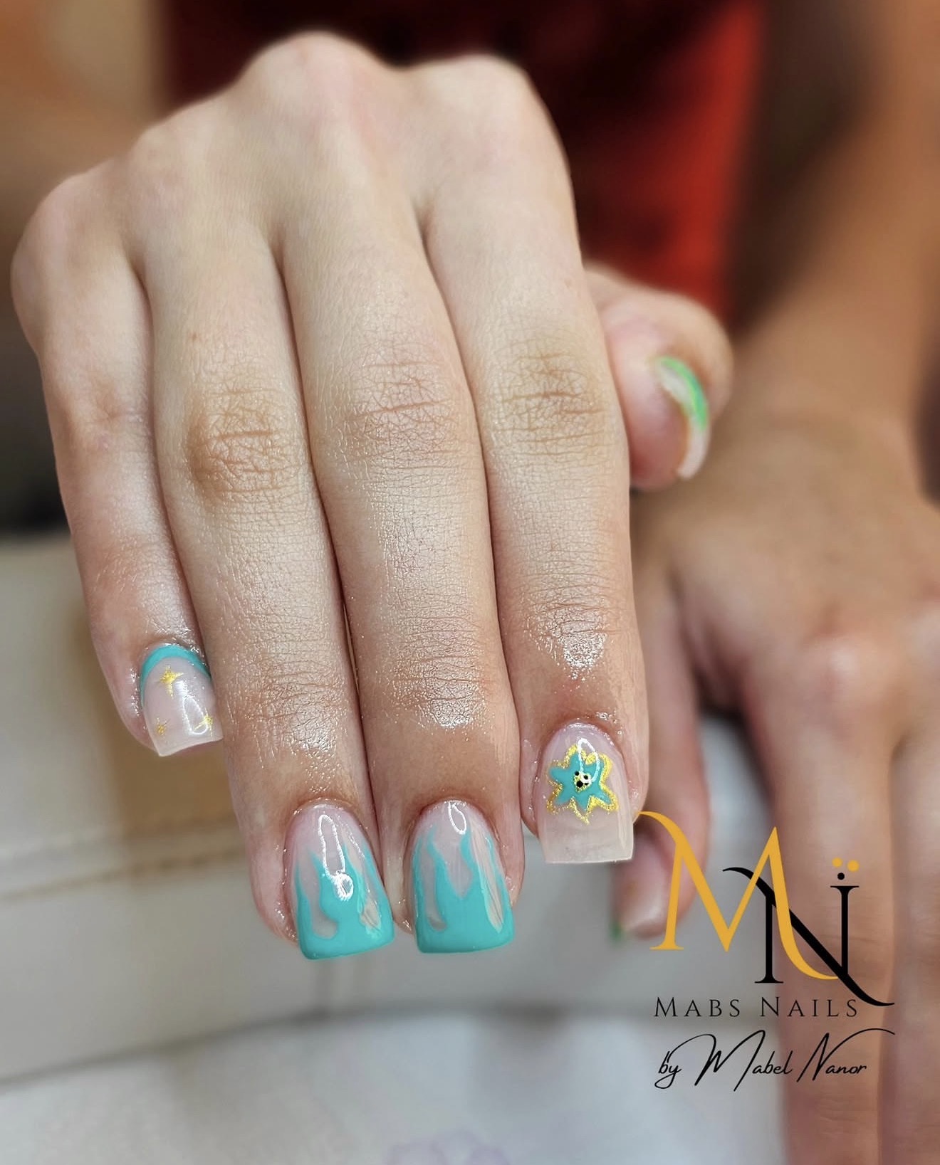 Teal flame nails with floral accent