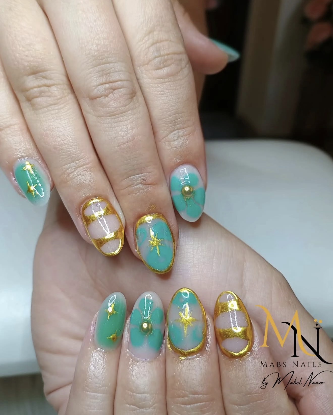 Teal and gold floral nail design